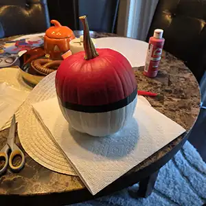 Add Black Electrical Tape Around the Middle of Your Halloween Pokémon Ball with white paint