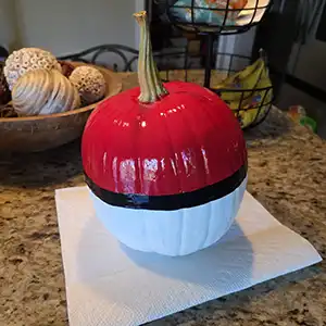 Spray the Entire Pumpkin with Clear Glossy Acrylic Sealer on Your Halloween Pokémon Ball with white paint